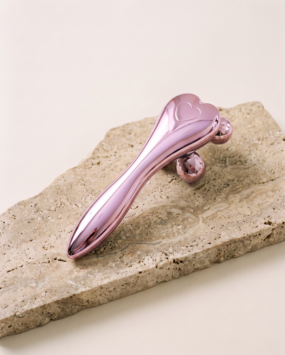Rouleau Sculpt 4D SCULVORA finition rosée, posé sur une pierre de travertin