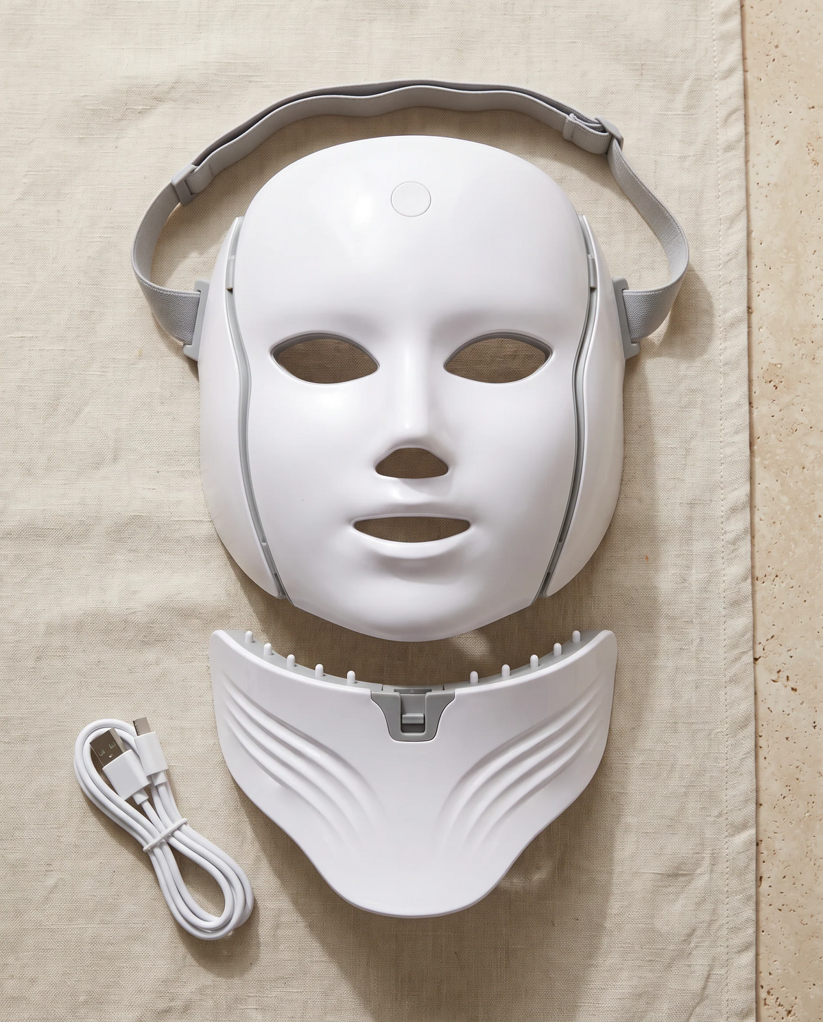 Contenu : masque visage, pièce cou amovible, sangle élastique et câble de charge
